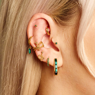 Green Stone baguette charm hoop earrings worn in helix piercing