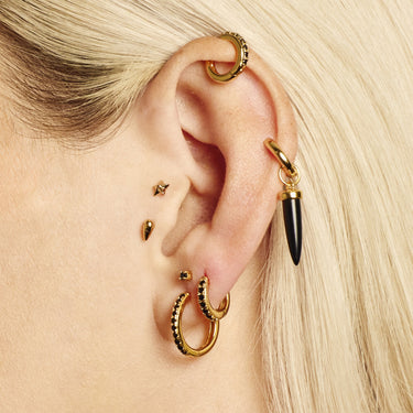 Large black stone hoop earring worn in lobe piercing