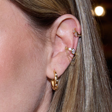 Close-Up of Gold Celestial Star Hoop Earrings