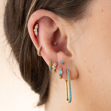 Turquoise huggie earring shown in lobe piercing also perfect for all cartilage piercings