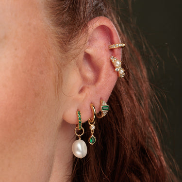 Close Up of a Pearl & Emerald Green Curated Ear Stack with Charm Hoops and Huggie Earrings