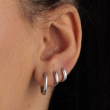 3 single hoop earrings in various sizes for cartilage piercings. Rook piercing, helix and conch piercings. on model