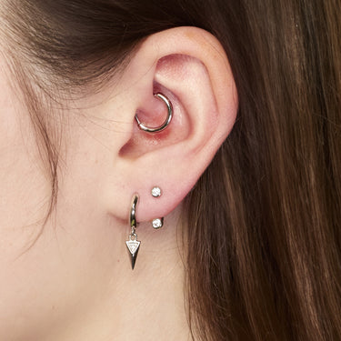 Silver Daith single earring in Daith piercing on model