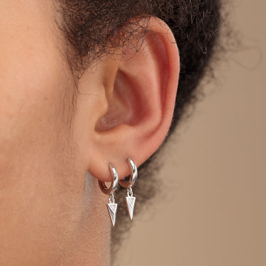 Silver Rebel Charm Hoop Earrings | Scream Pretty shown in lobe piercing
