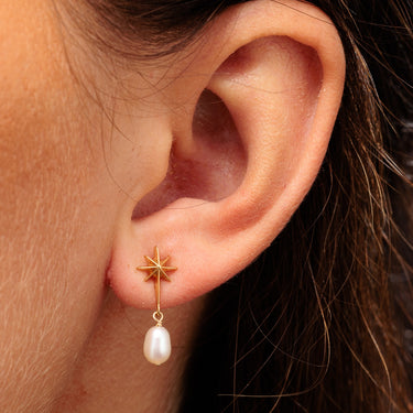 Gold Star Stud Earrings with Pearl Drop in Earlobe Piercing