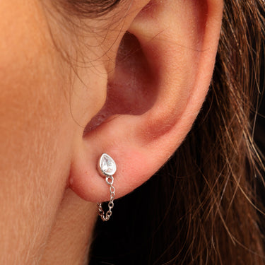 Silver Clear Stone Chained Teardrop Stud Earrings in Earlobe Piercing