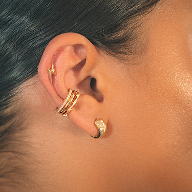 Woman Wearing Gold Lightning Bolt Stud Earrings | Lightning Motif Studs