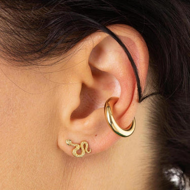 Woman Wearing Gold Snake Stud Earrings with Green Stones | Serpent Shaped Studs
