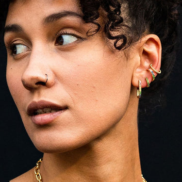 Green Huggie earring worn in second lobe piercing. Cartilage earrings for lobes and helix piercings