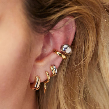 Mixed Metal Huggie shown on 3rd lobe piercing in mixed metal ear stack on model