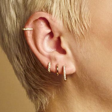 Gold Mini Sparkling Huggie Hoop Earrings in Helix and Upper Ear Lobe