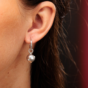 Silver Disco Ball Charm Hoop Earrings on Model