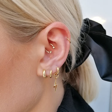 Classic Gold Huggie Hoop Earrings on Model's Ear