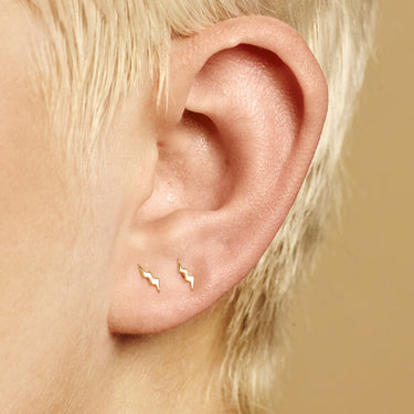 Woman Wearing Gold Dainty Lightning Bolt Stud Earrings | Lightning Shaped Studs