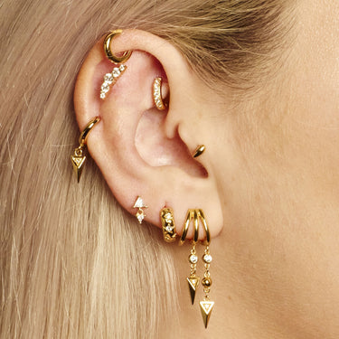 Gold Mini Huggie Hoop Earring in top cartilage helix piercing