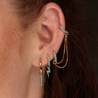 turquoise and gold curated ear stack in models ear