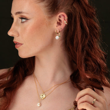 Woman Wearing Emerald Green & Pearl Jewellery