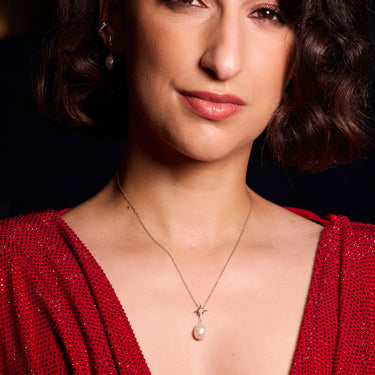 Woman Wearing Sparkling Star & Pearl Necklace in Silver with Red Dress