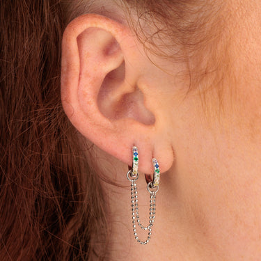 Silver Rainbow Chain Connector Double Huggie Earring worn in multiple ear lobe piercings