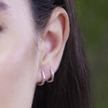 Claw Silver Huggie Earrings on ear perfect for all cartilage piercings