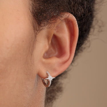 Starburst Silver Huggie Earrings with Clear Stones on Ear
