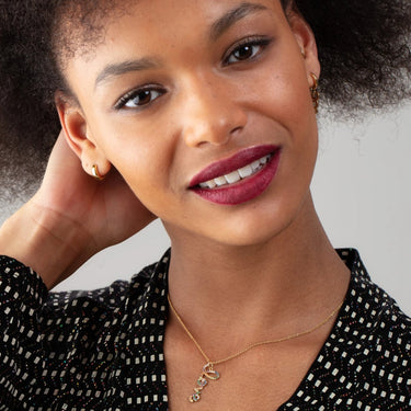 Chunky Gold Huggie Hoop Earrings on model 