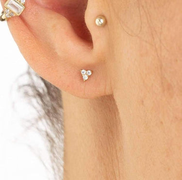 Woman Wearing Gold Sparkling Trinity Stud Earrings | Dainty Clear Stone Stud Earrings