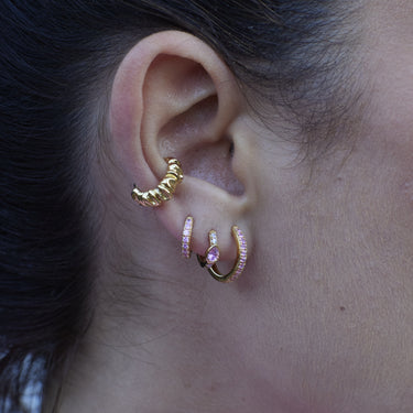 Gold Huggie Earrings with Pink Stones in a curated ear stack