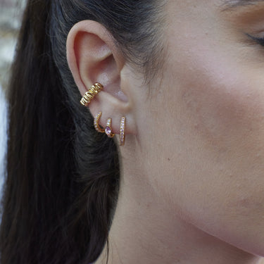 Gold Huggie Earrings with Pink Stones on model