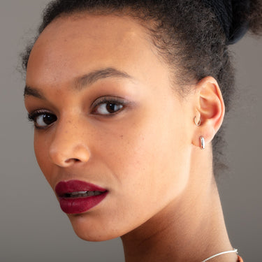 Chunky Silver Huggie Hoop Earrings on model 