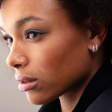Stardust Silver Huggie Earrings with Clear Stones on Model worn in first and second lobe piercings